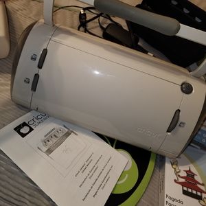 Cricut with cord and cricut jukebox with several cartridges